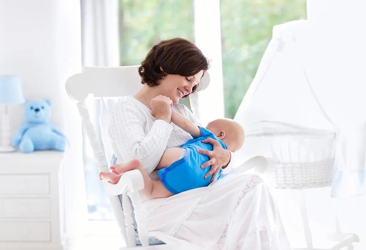 Mother rocking her baby to soothe colic