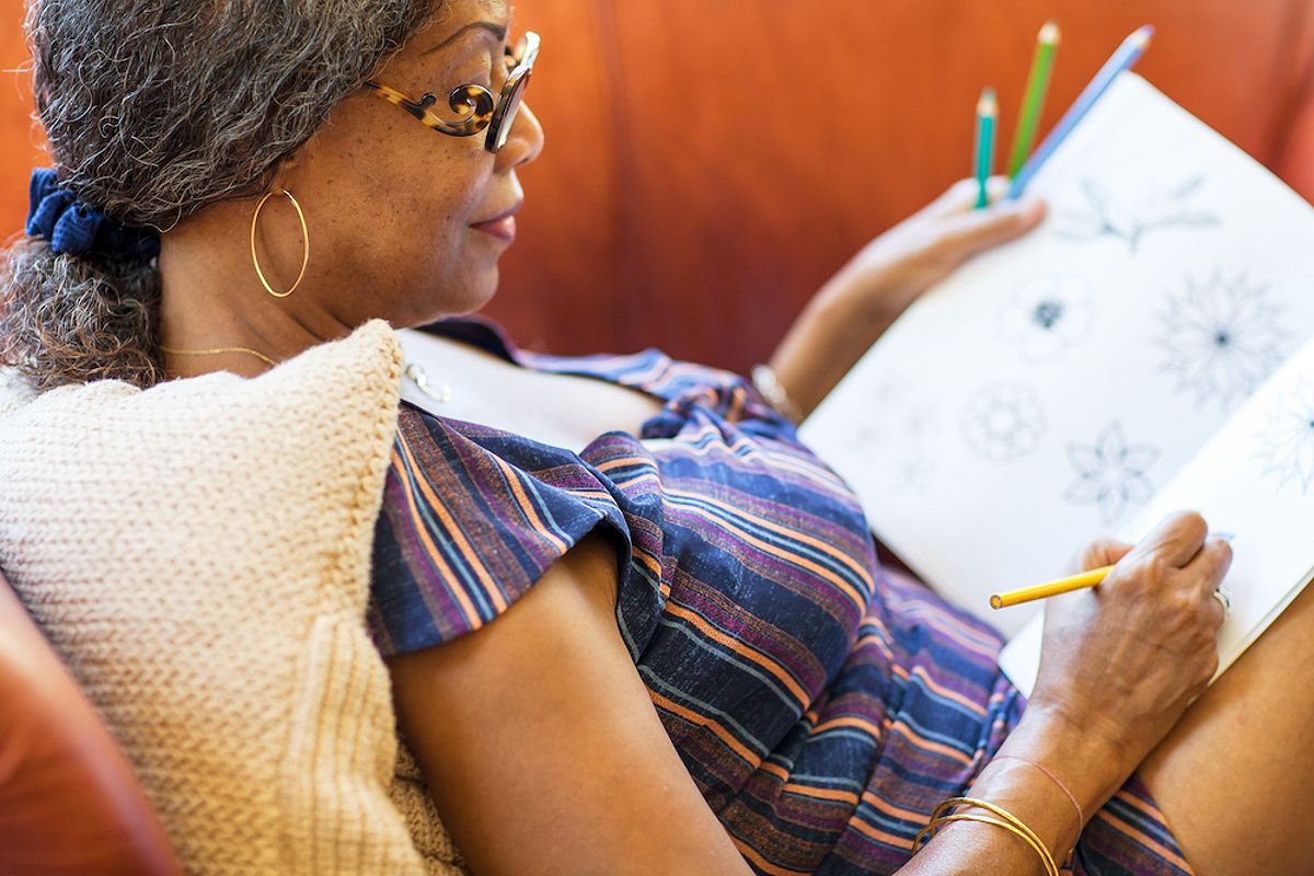 Senior woman coloring in a coloring book